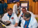 Representatives from the ARRL Lab conduct hand-held radio testing. (L-R) ARRL Lab Senior Test Engineer Bob Allison, WB1GCM; EMI Expert Mike Gruber, W1MG, West Central Florida Section Manager Darrell Davis, KT4WX, and Pete Turbide, W1PT. [Rick Lindquist, WW1ME, photo]